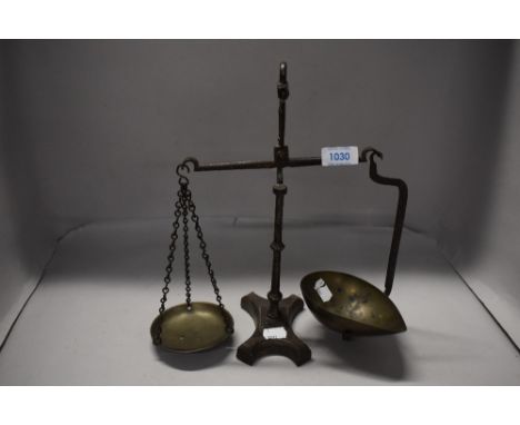 A set of Victorian apothecary or similar balance scales, cast iron frame with brass pans