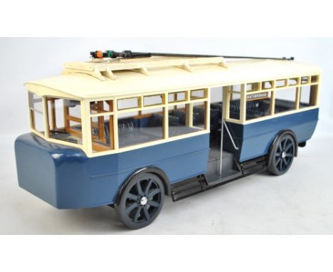 A large model of a tram, length 76cm, and a small quantity of model vehicles. CONDITION REPORT: A few scuffs, fading to paint