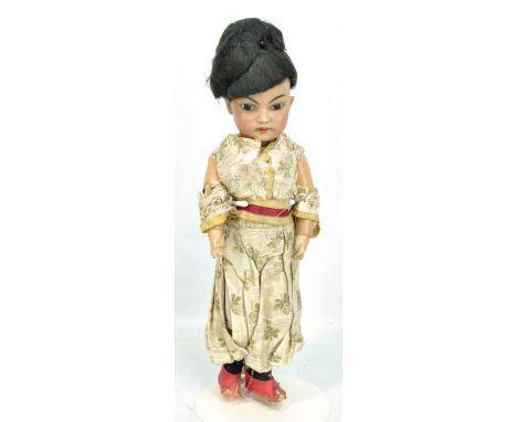 A Simon &amp; Halbig (probably) Oriental bisque headed doll with black wig, painted features, brown glass eyes and open mouth