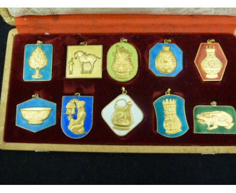 A Set of 10 Peking Jewellery Chinese gilt metal and enamel pendants, inscriptions verso, presentation box (11)