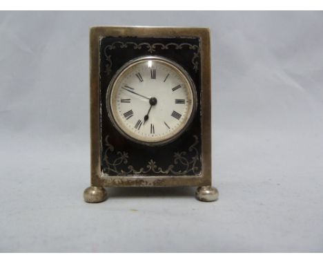 A silver pique work miniature carriage clock, with french movement, the silver box frame on four ball feet, white enamel circ