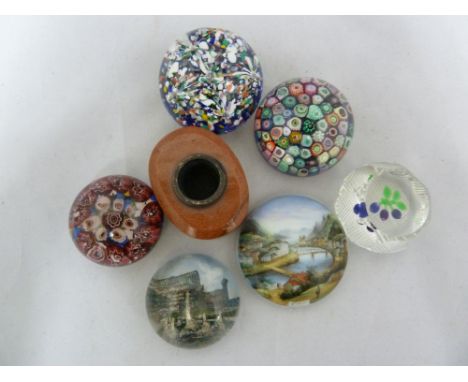 A group of paperweights, including a small size weight with centrally placed sprig of three plums; a Bohemian weight with a v
