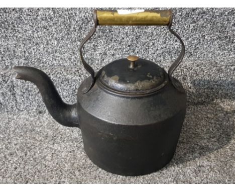 A cast metal and brass handled stove teapot.