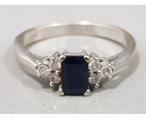 Ladies 9ct white gold sapphire &amp; diamond ring, comprising of a blue emerald cut sapphire set with 3 round brilliant cut d