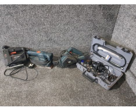 Three Black &amp; Decker power tools and a Dremel.