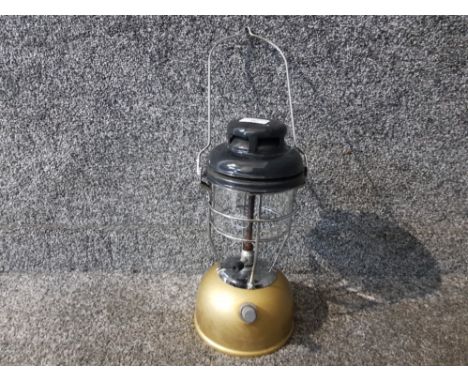 A Tilley lamp with gold coloured base.
