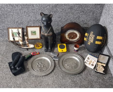 A wooden ornament of an Egyptian cat, two pewter chargers, an oak mantle clock by Andrew, zippo lighters etc.
