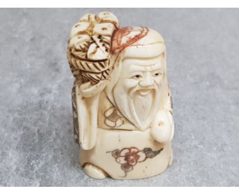 A finely carved bone netsuke of an elder with basket of bread.
