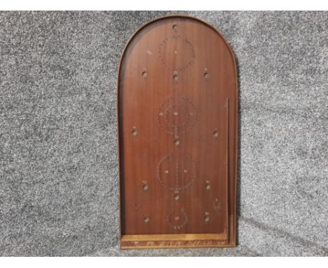 A bagatelle board with balls.