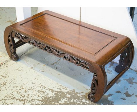 LOW TABLE, 20th century, Chinese, padoukwood with carved scroll end supports, 97cm W x 33cm H x 45cm D.