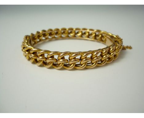 A 15ct gold hinged bangle in the form of a double curb link chain, 23.7g