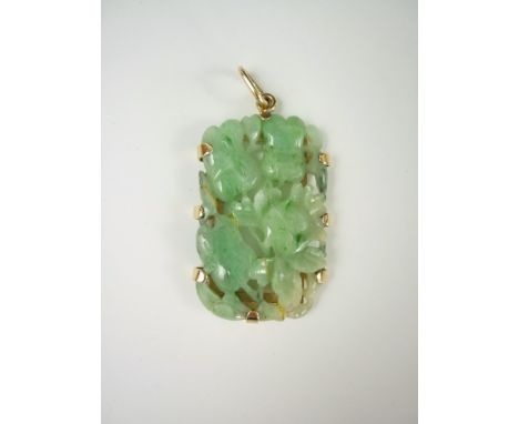 A 9ct gold and jade pendant, the oblong section stone being carved and reticulated in depiction of blossom, 3.5 cm  
