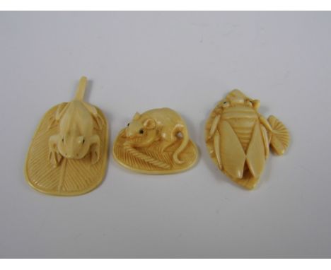 Three signed Meiji Japanese ivory netsuke modelled respectively as a rat and a frog on leaves, and a locust on a fan