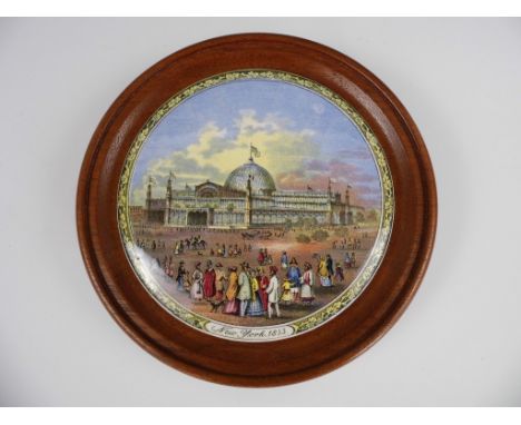 A Victorian Prattware pot lid entitled 'New York 1853', decorated with the New York Exhibition Hall, in a turned wooden frame