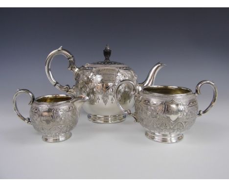 A Victorian EPBM tea service, comprising teapot, sugar bowl and milk jug, each of bullet form and profusely engraved, the pot