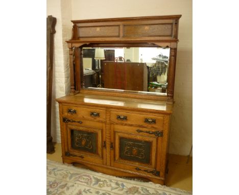 A Victorian Arts and Crafts oak mirror-backed sideboard, the back having a marquetry inlaid panelled frieze above a high shel