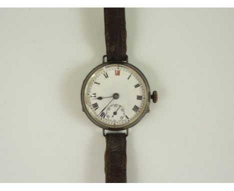 A 1920s silver-cased wrist watch, having a pin-set un-named movement and white enamel dial with subsidiary seconds