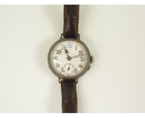 A 1918 silver trench watch, having a pin-set un-named movement and white enamel dial with subsidiary seconds