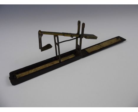 A set of George III mahogany cased brass pocket guinea scales, retailed by A. Wilkinson of Kirkby near Liverpool, 13 cm 