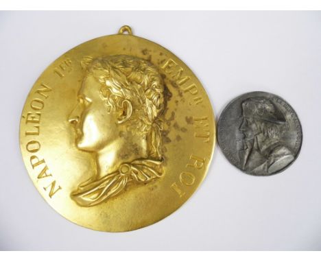A 19th Century gilt brass wall plaque bearing a relief profile portrait of Napoleon Bonaparte and the legend Napoleon 1er Emp