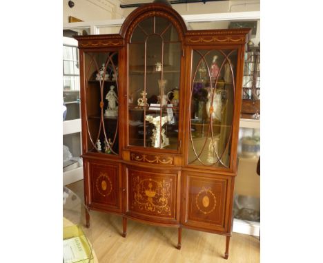 A late 19th / early 20th Century Sheraton revival marquetry-inlaid mahogany display cabinet, having a pediment with central a