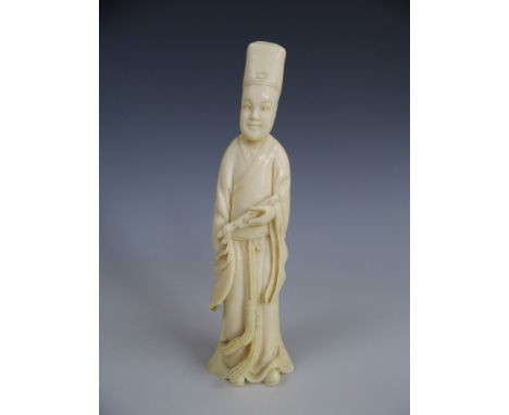 A Meiji Japanese ivory okimono modelled as a musician with pipe, 12 cm high