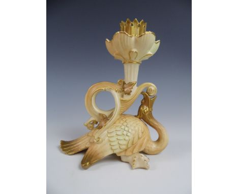 A Royal Worcester grotesque candlestick modelled as a stylized fantastical bird supporting a reeded column and a crenelated s