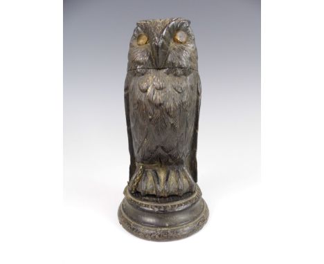 A 19th Century novelty carved wood inkwell in the form of a chained owl, having faceted paste eyes, 15 cm 