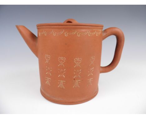 A Chinese Yixing teapot, of cylindrical form decorated with impressed character devices, character mark to base, 19th Century