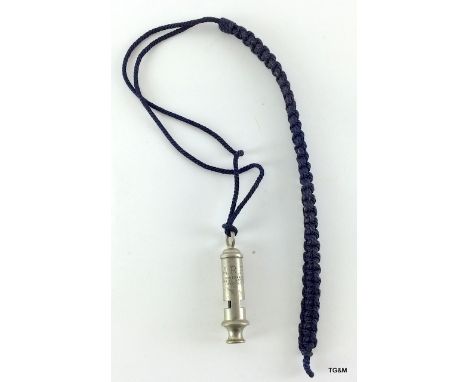 A WW2 Air Raid Precautions ARP whistle by Hudson & Co on its lanyard