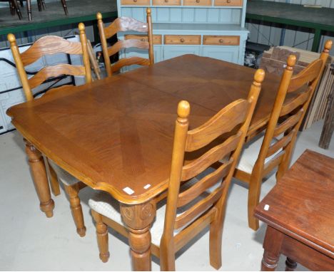 Light oak extending table and a set of four dining chairs with upholstered seats 