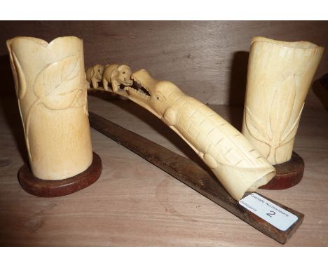 Carved ivory tusk depicting crocodile & elephant and two carved ivory vases with relief moulded leaf decoration 