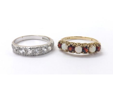9ct seven stone half hoop ring, consisting of four garnets and three cabouchon opals, London 1979, 1.8gm, ring size P; also a