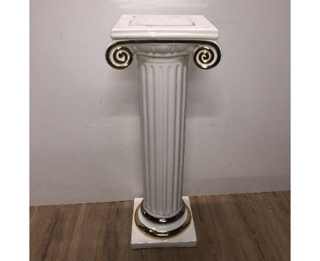 A CREAM AND GILT CERAMIC PLINTH