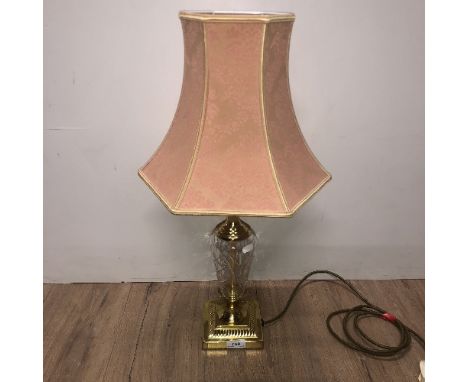A GILDED AND GLASS BASED TABLE LAMP AND MATCHING SHADE