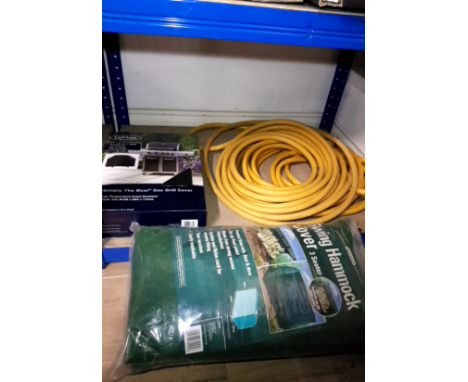 A SWING HAMMOCK COVER A GAS GRILL COVER AND A HAUSER PIPE