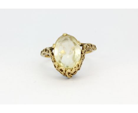 An unusual 9ct yellow gold ring set with a large oval cut citrine, (Q.5).