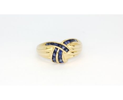 A 14ct yellow gold (stamped 14k) ring set with square cut sapphires, (Q).