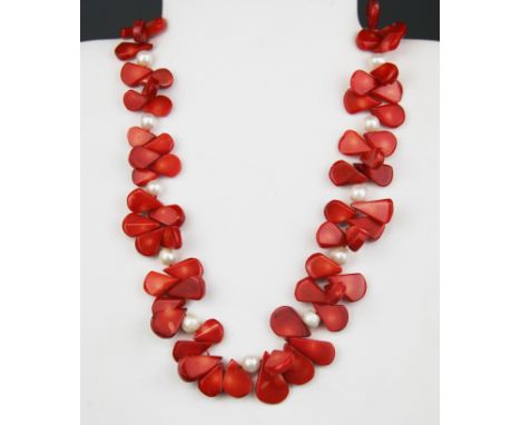An unusual carved coral and cultured pearl beaded necklace on a gilt metal clasp, approx. L. 46cm.