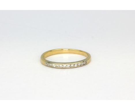 A 14ct yellow gold (stamped 14k) half eternity ring set with diamonds, (L).