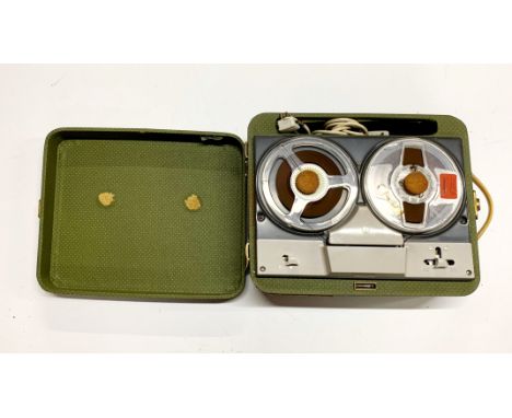 A vintage portable reel-to-reel tape recorder.