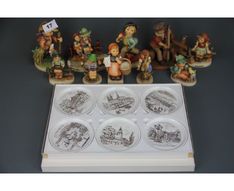 A group of Hummel figurines, together with a Black Forest figure of a boy with a dog and a box of six German porcelain dishes