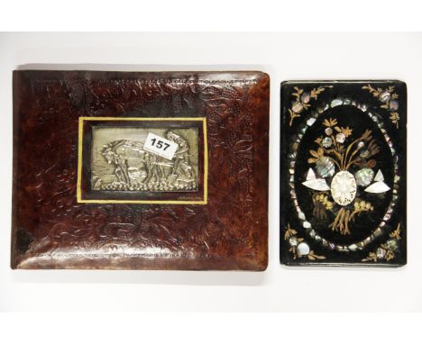 A white metal inset leather bound desk blotter together with a Victorian mother of pearl inset papier mache desk blotter, lar
