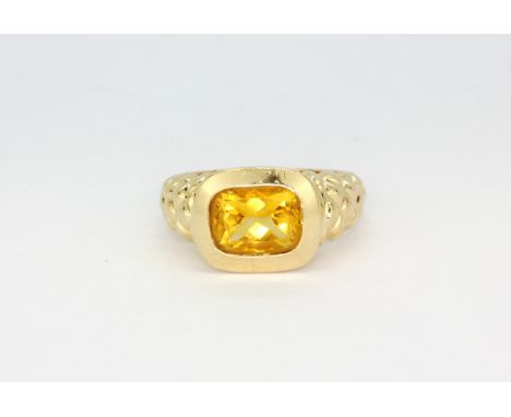 A 14ct yellow gold (stamped 14k) ring with a rub over set citrine, (M.5).