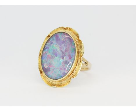 A 14ct yellow gold ring set with a large opal triplet, (N.5).