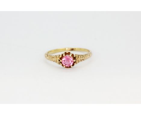 A 14ct yellow gold (stamped 14k) solitaire ring set with a round cut pink topaz, (O.5).