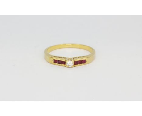 A yellow metal (tested minimum 9ct gold) ring set with a diamond and square cut ruby set shoulders, (O).