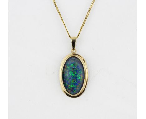 A large 9ct yellow gold (stamped 375) opal triplet set pendant (L.3cm) on a 9ct yellow gold chain, L. 40cm.