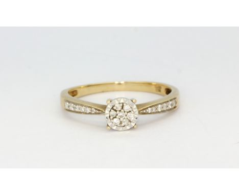 A 9ct yellow gold diamond set cluster ring with diamond set shoulders, (S), approx. 2.2gr.