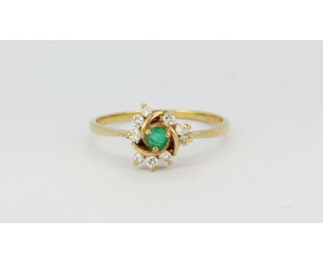 A 9ct yellow gold ring set with a round cut emerald and diamonds, (P), approx. 1.3gr.